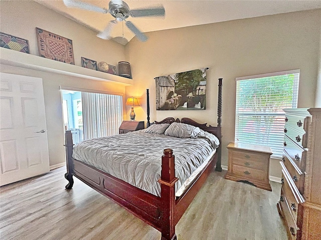 bedroom featuring multiple windows, ceiling fan, and light wood-type flooring