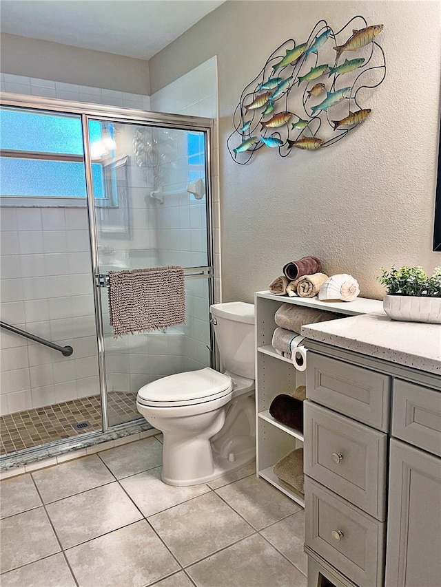 bathroom with tile patterned floors, toilet, and walk in shower