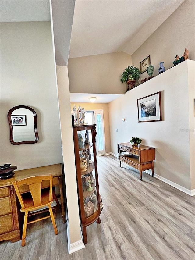 interior space with lofted ceiling and light wood-type flooring