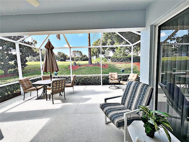 view of patio featuring a lanai