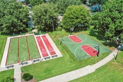 view of sport court with a yard