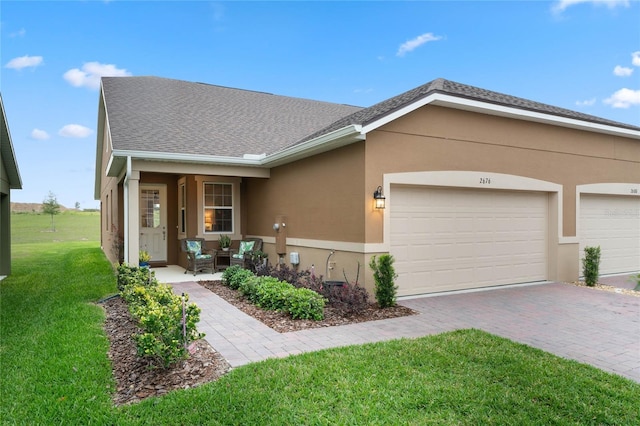 ranch-style house with a garage and a front lawn