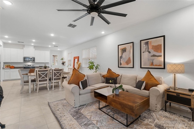 tiled living room with ceiling fan