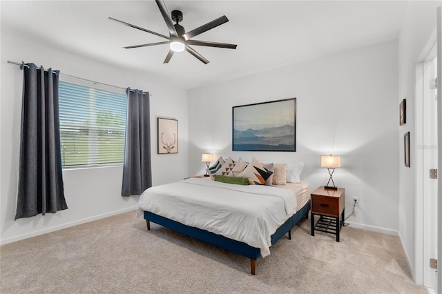 bedroom featuring light carpet and ceiling fan