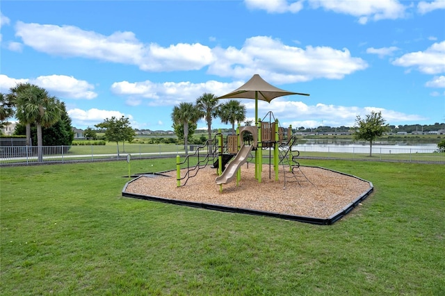 view of jungle gym featuring a water view and a yard