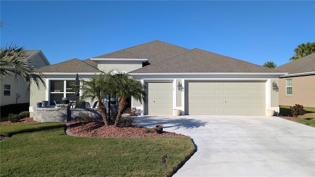 view of front facade with a garage and a front lawn