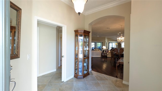 corridor featuring a chandelier and ornamental molding