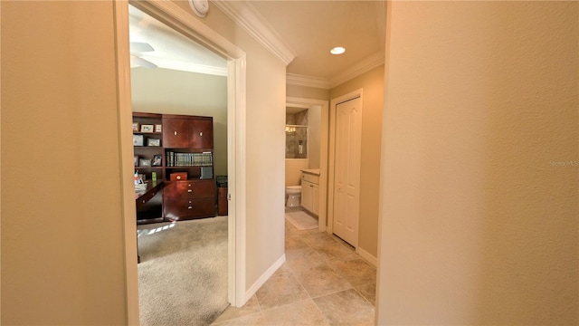 hallway featuring light colored carpet and ornamental molding