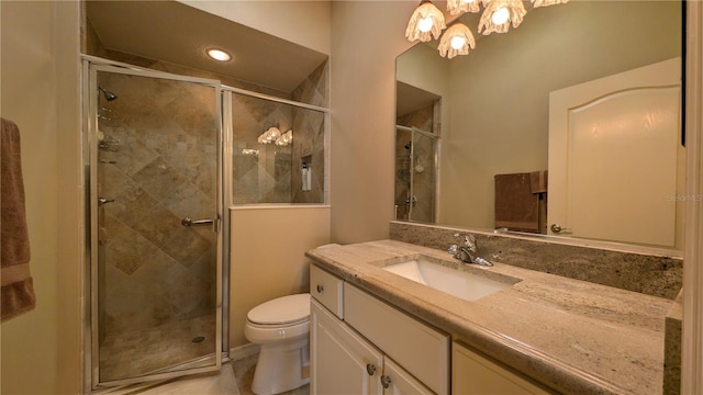 bathroom featuring walk in shower, vanity, and toilet