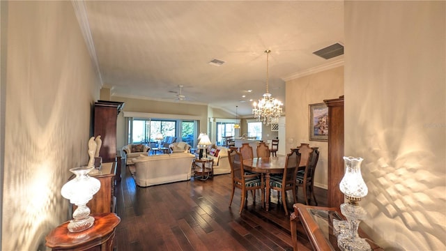 dining room featuring ornamental molding, ceiling fan with notable chandelier, and dark wood-type flooring