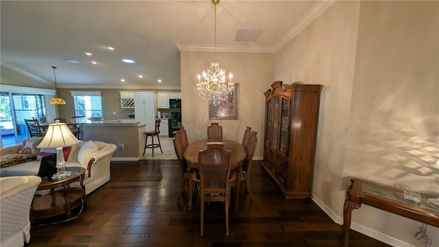 dining area with crown molding, a chandelier, and dark hardwood / wood-style floors