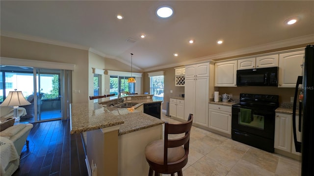 kitchen with sink, white cabinetry, a kitchen island with sink, and black appliances