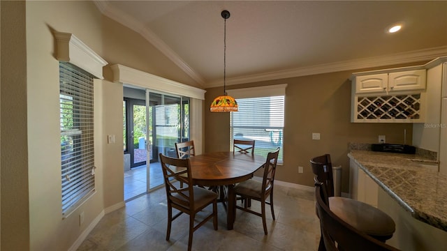 dining area with crown molding and lofted ceiling