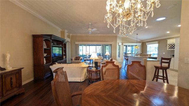 dining space with crown molding, dark hardwood / wood-style flooring, and ceiling fan with notable chandelier