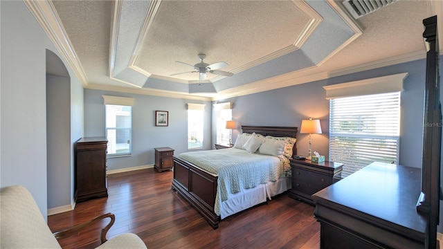 bedroom with a raised ceiling, crown molding, ceiling fan, a textured ceiling, and dark hardwood / wood-style flooring