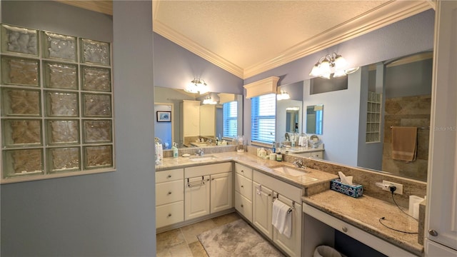 bathroom featuring a textured ceiling, vanity, lofted ceiling, and ornamental molding