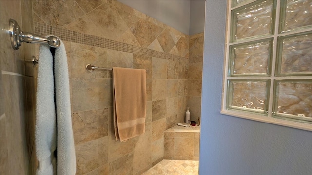 bathroom featuring a tile shower