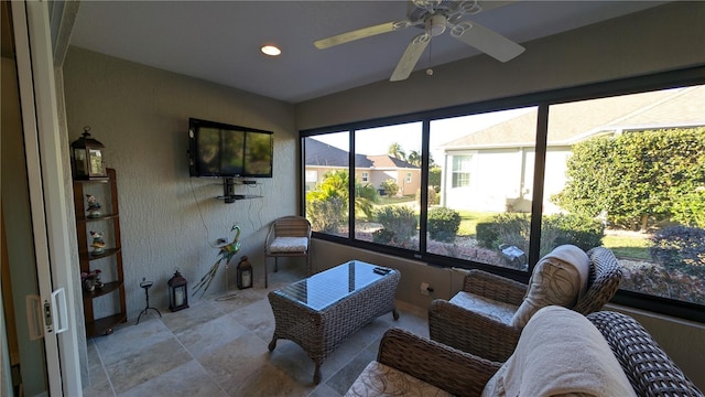 sunroom / solarium featuring ceiling fan and a wealth of natural light