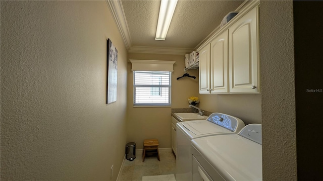 clothes washing area featuring cabinets, sink, crown molding, washer and dryer, and a textured ceiling