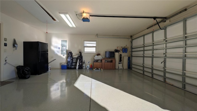 1881 Sassparilla Way, The Villages, FL 32162 - garage with freestanding refrigerator, electric panel, and a garage door opener