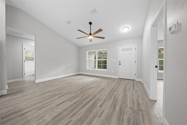 unfurnished living room with ceiling fan and lofted ceiling