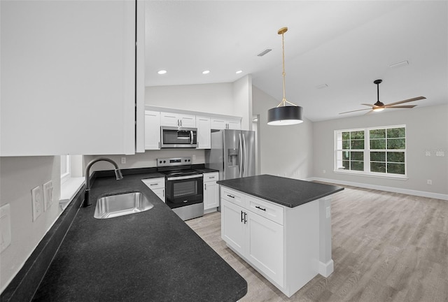 kitchen with white cabinetry, a center island, sink, stainless steel appliances, and vaulted ceiling