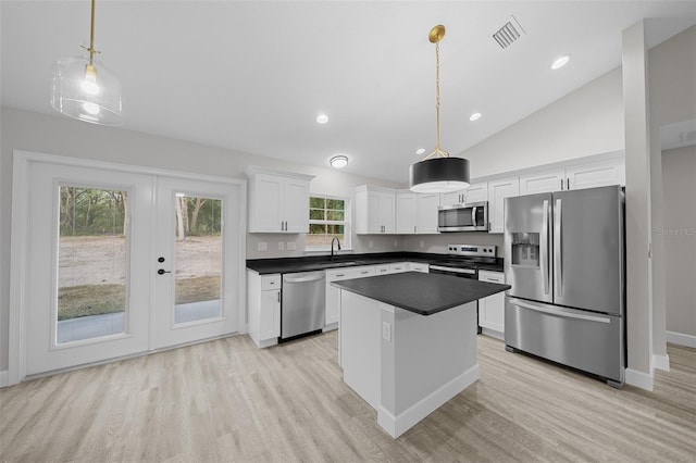 kitchen featuring pendant lighting, stainless steel appliances, white cabinetry, and sink