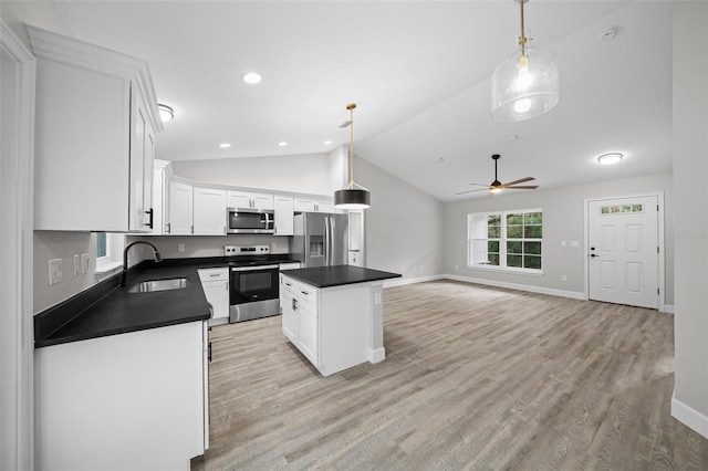 kitchen with sink, a center island, pendant lighting, and appliances with stainless steel finishes