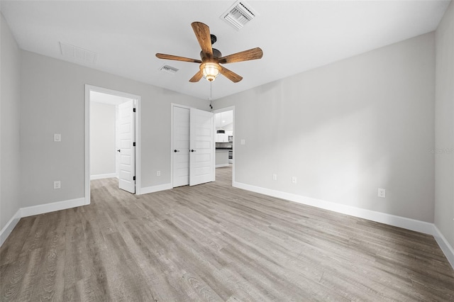 unfurnished bedroom featuring ceiling fan and light hardwood / wood-style floors