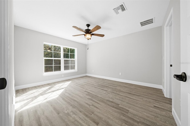 spare room featuring ceiling fan and hardwood / wood-style flooring