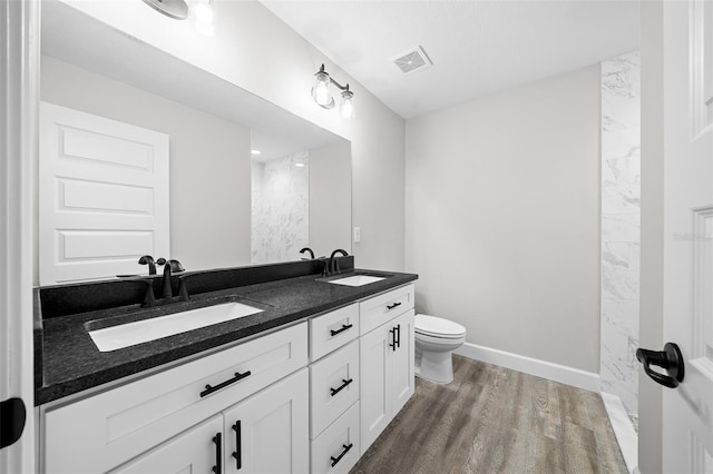 bathroom featuring hardwood / wood-style floors, vanity, and toilet