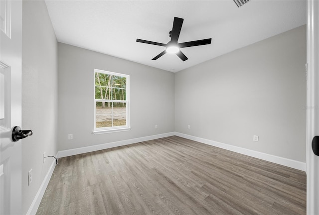 spare room featuring light wood-type flooring and ceiling fan