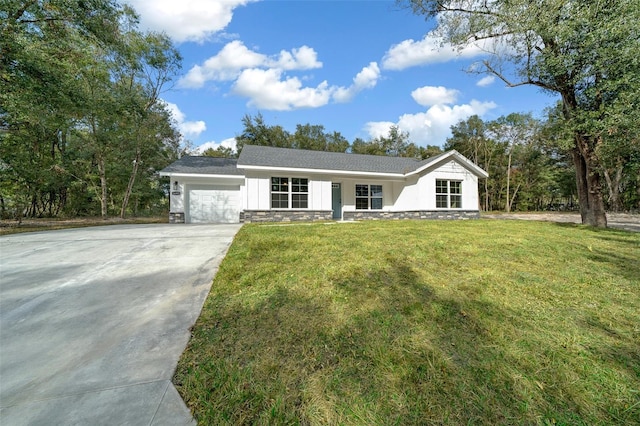 single story home with a garage and a front yard