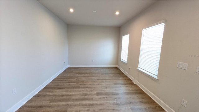 empty room with light hardwood / wood-style flooring and plenty of natural light