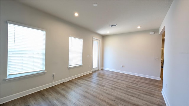 spare room with light hardwood / wood-style floors