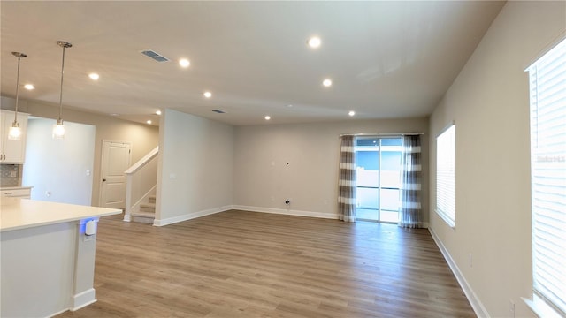 unfurnished living room with light hardwood / wood-style flooring