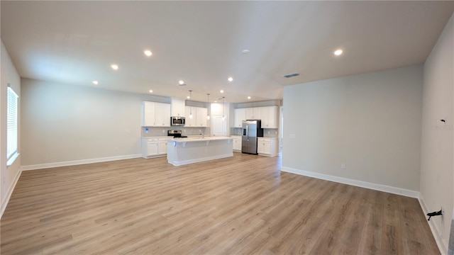 unfurnished living room featuring light hardwood / wood-style flooring