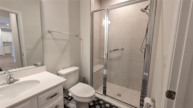 bathroom featuring vanity, toilet, and walk in shower