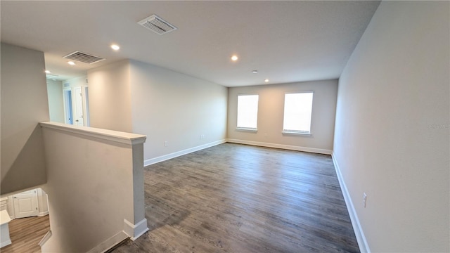 spare room with dark wood-type flooring