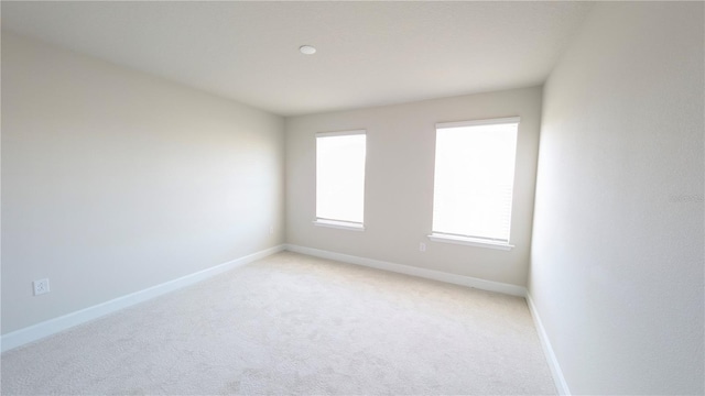 unfurnished room with light colored carpet