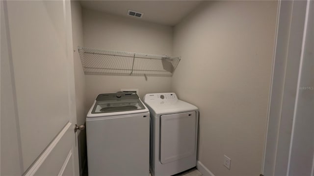 clothes washing area featuring independent washer and dryer