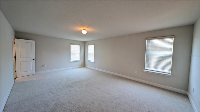 unfurnished room with light colored carpet