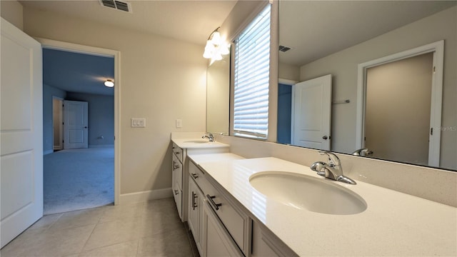 bathroom with tile patterned flooring and vanity