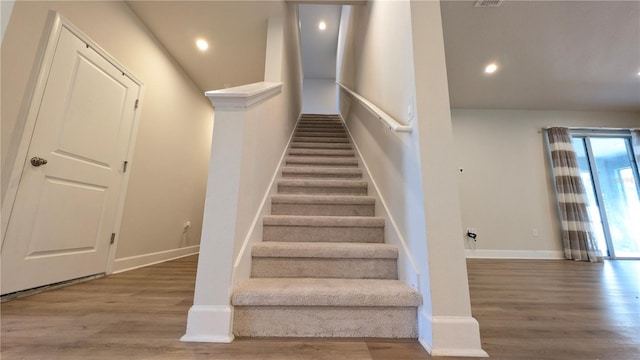 stairs featuring hardwood / wood-style flooring