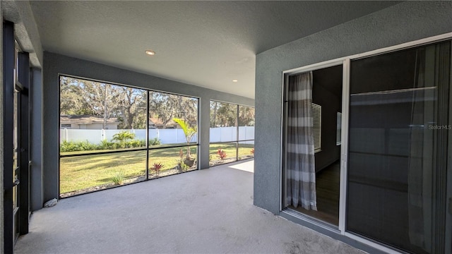 unfurnished sunroom featuring a water view