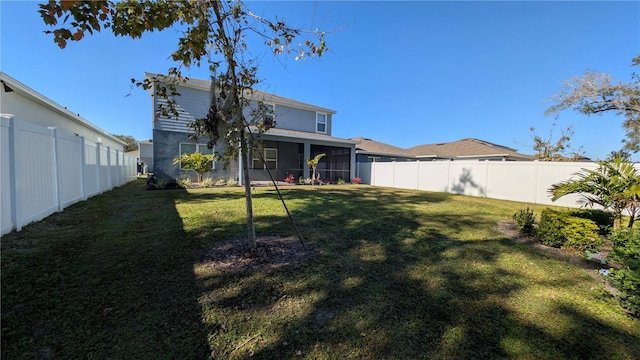 rear view of property with a yard and a sunroom