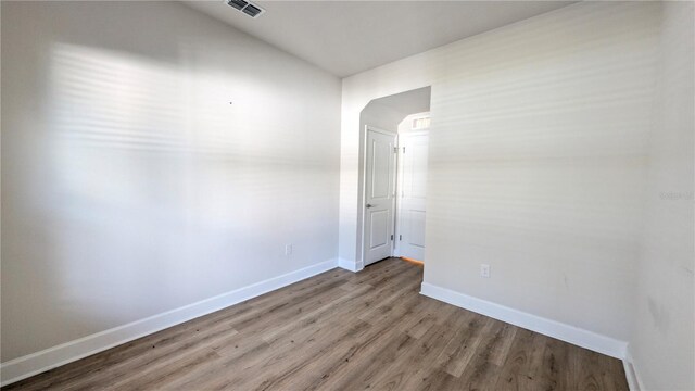 unfurnished room featuring hardwood / wood-style flooring