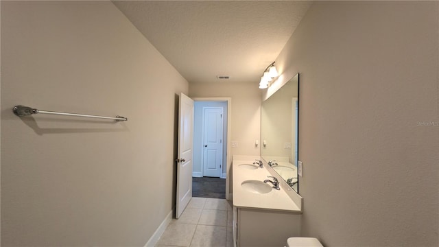 bathroom featuring tile patterned floors, vanity, and a textured ceiling