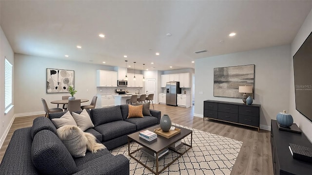 living room with light hardwood / wood-style flooring