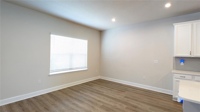 unfurnished dining area featuring dark hardwood / wood-style flooring